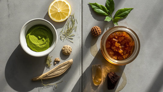 An overhead split view showcasing a Yaupon vs green tea ingredient layout with matcha powder, lemon slices, and honey jars.