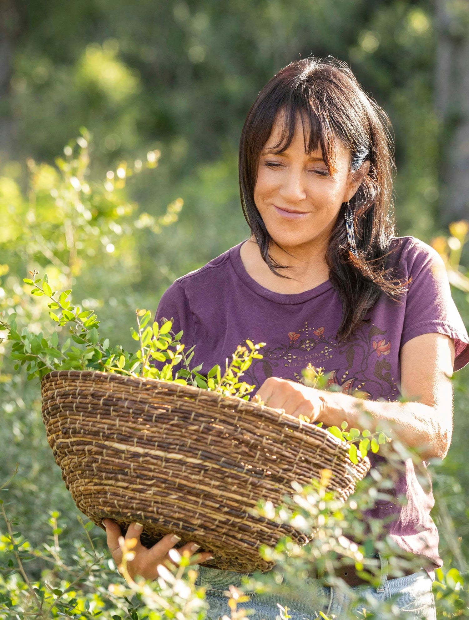 Bobbie Harris, co-founder of Catawba Yaupon, harvesting fresh yaupon holly leaves